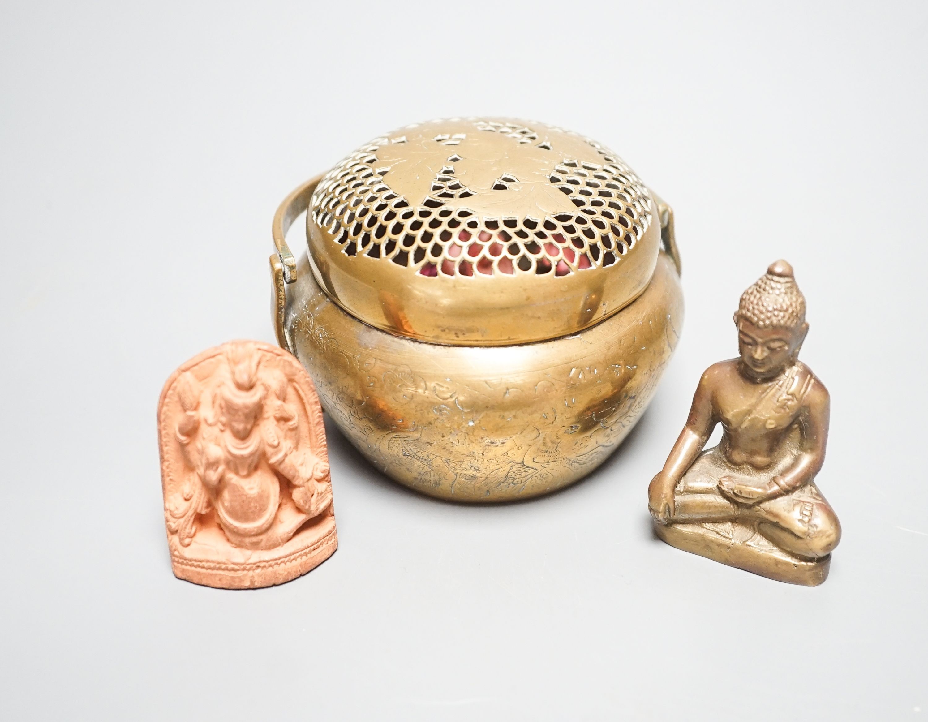 A bronze hand warmer with Xuande mark, 10 cm wide and two Himalayan Buddhist figures, tallest 6.8 cm (3)